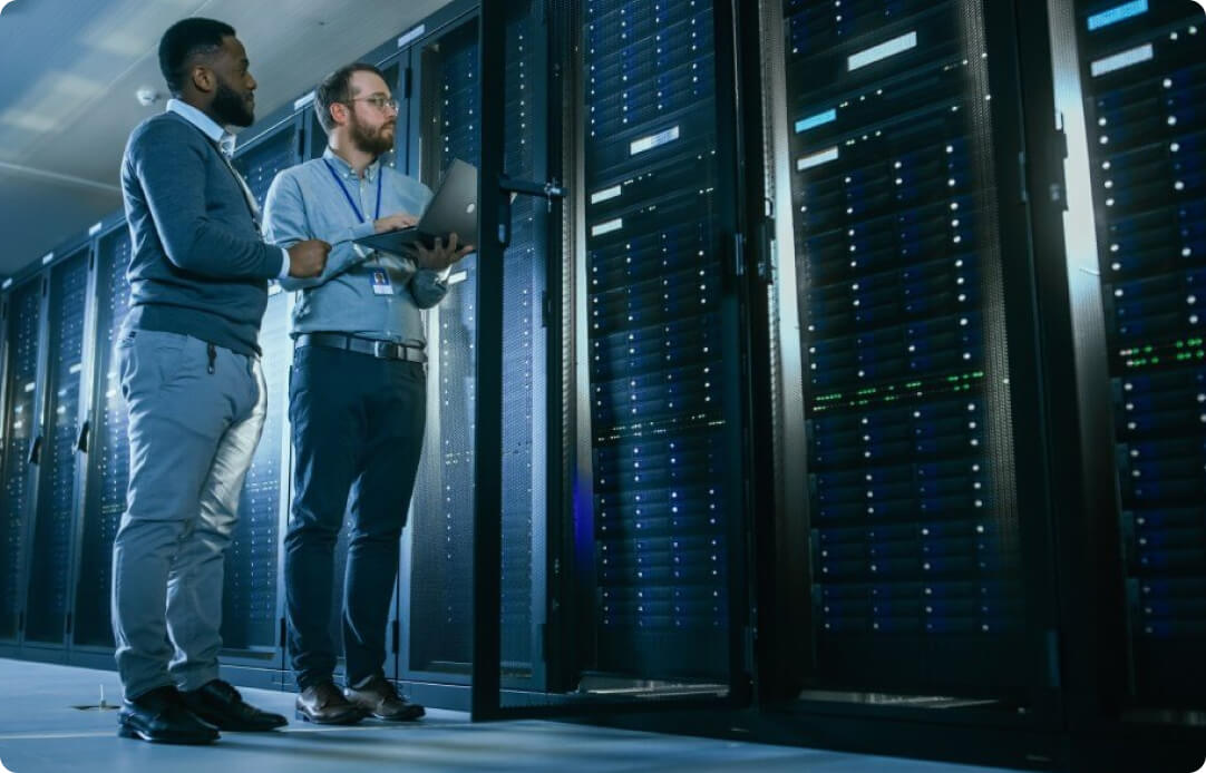 Mens standing on a server room